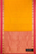 Mustard Dual Tone Kanchipuram Silk Saree with Zari Butta on the body and Zari Border.  displayed on a mannequin