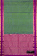 Mehandi Green Dual Tone Kanchipuram Silk Saree with Stripes on the body and Zari Border.  displayed on a mannequin