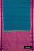 Peacock Blue Dual Tone Kanchipuram Silk Saree with Stripes on the body and Zari Border.  displayed on a mannequin