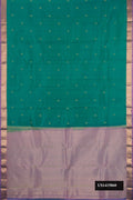 Green Dual Tone Kanchipuram Silk Saree with Zari Butta on the body and Zari Border.  displayed on a mannequin