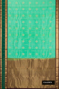 Pista Green Dual Tone Kanchipuram Silk Saree with Zari Butta on the body and Fancy Border.  displayed on a mannequin