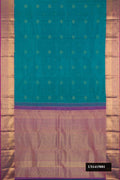 Green Dual Tone Kanchipuram Silk Saree with Zari Butta on the body and Zari Border.  displayed on a mannequin