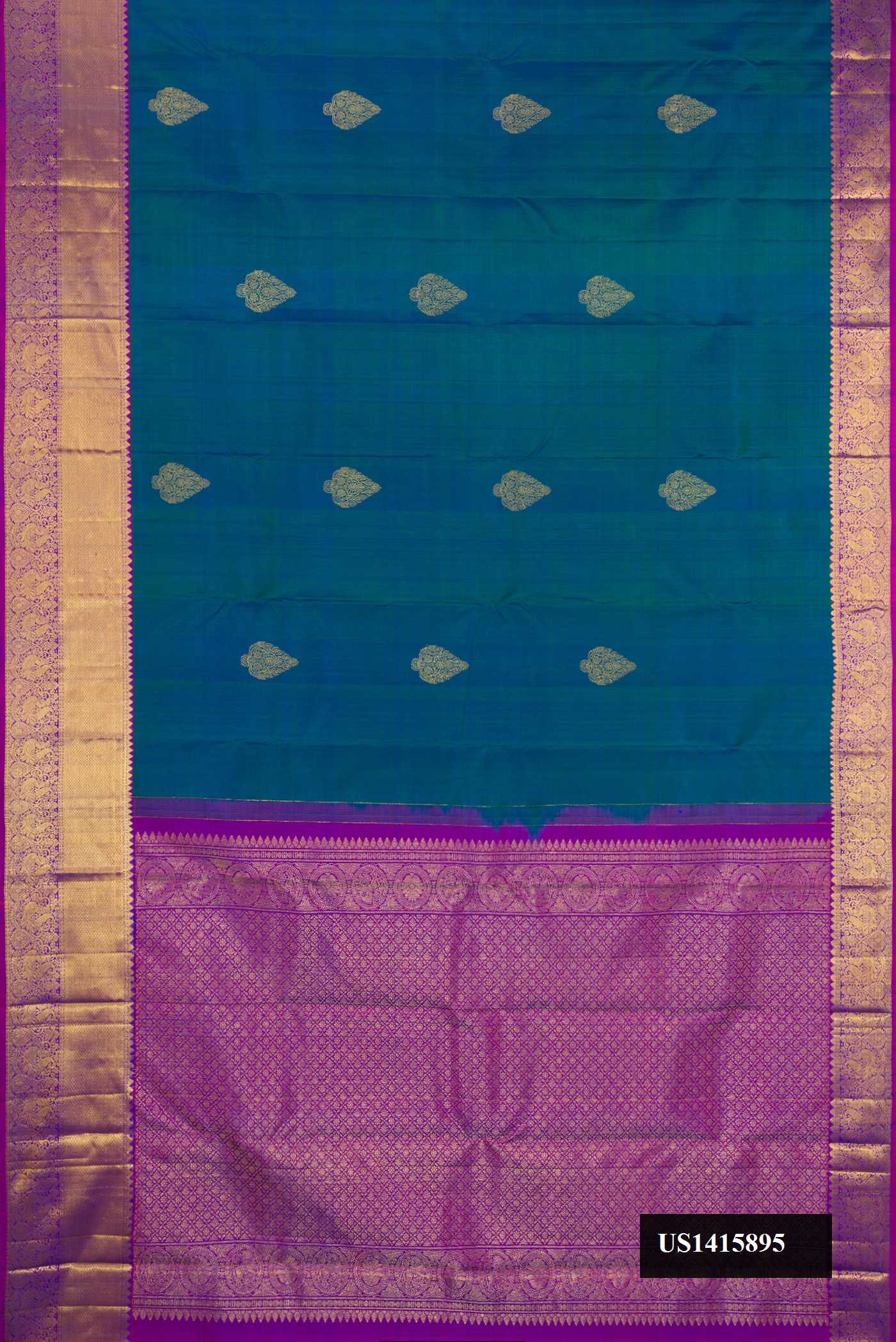 Peacock Blue Dual Tone Kanchipuram Silk Saree with Zari Butta on the body and Zari Border.  displayed on a mannequin