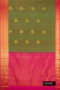 Green Dual Tone Kanchipuram Silk Saree with Zari Butta on the body and Zari Border.  displayed on a mannequin