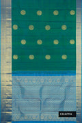 Green Dual Tone Kanchipuram Silk Saree with Zari Butta on the body and Zari Border.  displayed on a mannequin