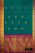 Green Dual Tone Kanchipuram Silk Saree with Zari Butta on the body and Zari Border.  displayed on a mannequin