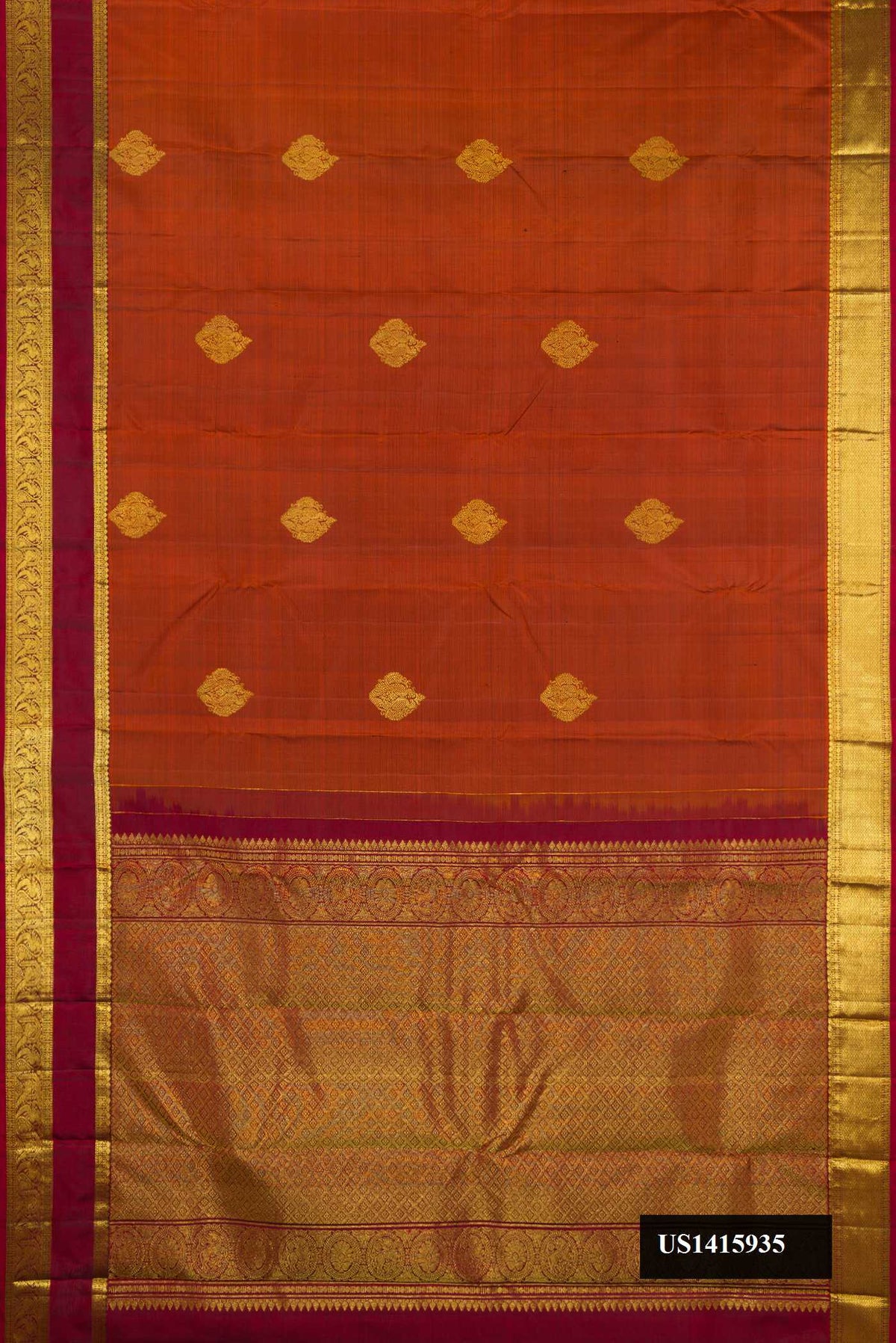 Brick Orange Dual Tone Kanchipuram Silk Saree with Zari Butta on the body and Zari Border.  displayed on a mannequin