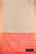 Beige Dual Tone Kanchipuram Silk Saree with Zari Butta on the body and Zari Border.  displayed on a mannequin