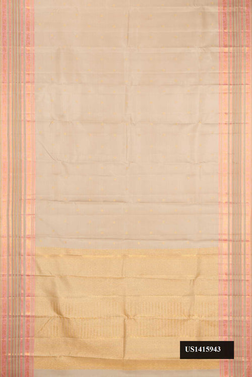 Beige Dual Tone Kanchipuram Silk Saree with Zari Butta on the body and Zari Border.  displayed on a mannequin