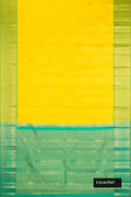 Yellow Dual Tone Kanchipuram Silk Saree with Zari Butta on the body and Zari Border.  displayed on a mannequin