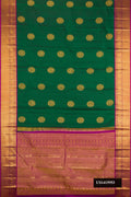 Green Dual Tone Kanchipuram Silk Saree with Zari Butta on the body and Zari Border.  displayed on a mannequin