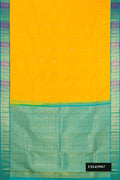 Yellow Dual Tone Kanchipuram Silk Saree with Zari Butta on the body and Zari Border.  displayed on a mannequin