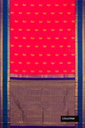 Coral Dual Tone Kanchipuram Silk Saree with Zari Butta on the body and Zari Border.  displayed on a mannequin