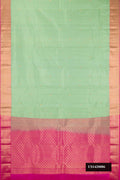 Pista Green Dual Tone Kanchipuram Silk Saree with Zari Butta on the body and Zari Border.  displayed on a mannequin