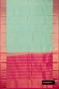 Pista Green Dual Tone Kanchipuram Silk Saree with Zari Butta on the body and Zari Border.  displayed on a mannequin