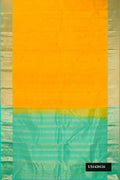 Mustard Dual Tone Kanchipuram Silk Saree with Zari Butta on the body and Zari Border.  displayed on a mannequin