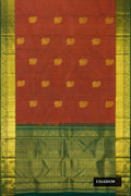 Rust Dual Tone Kanchipuram Silk Saree with Zari Butta on the body and Zari Border.  displayed on a mannequin