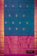 Peacock Blue Dual Tone Kanchipuram Silk Saree with Zari Butta on the body and Zari Border.  displayed on a mannequin