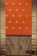 Rust Dual Tone Kanchipuram Silk Saree with Zari Butta on the body and Zari Border.  displayed on a mannequin