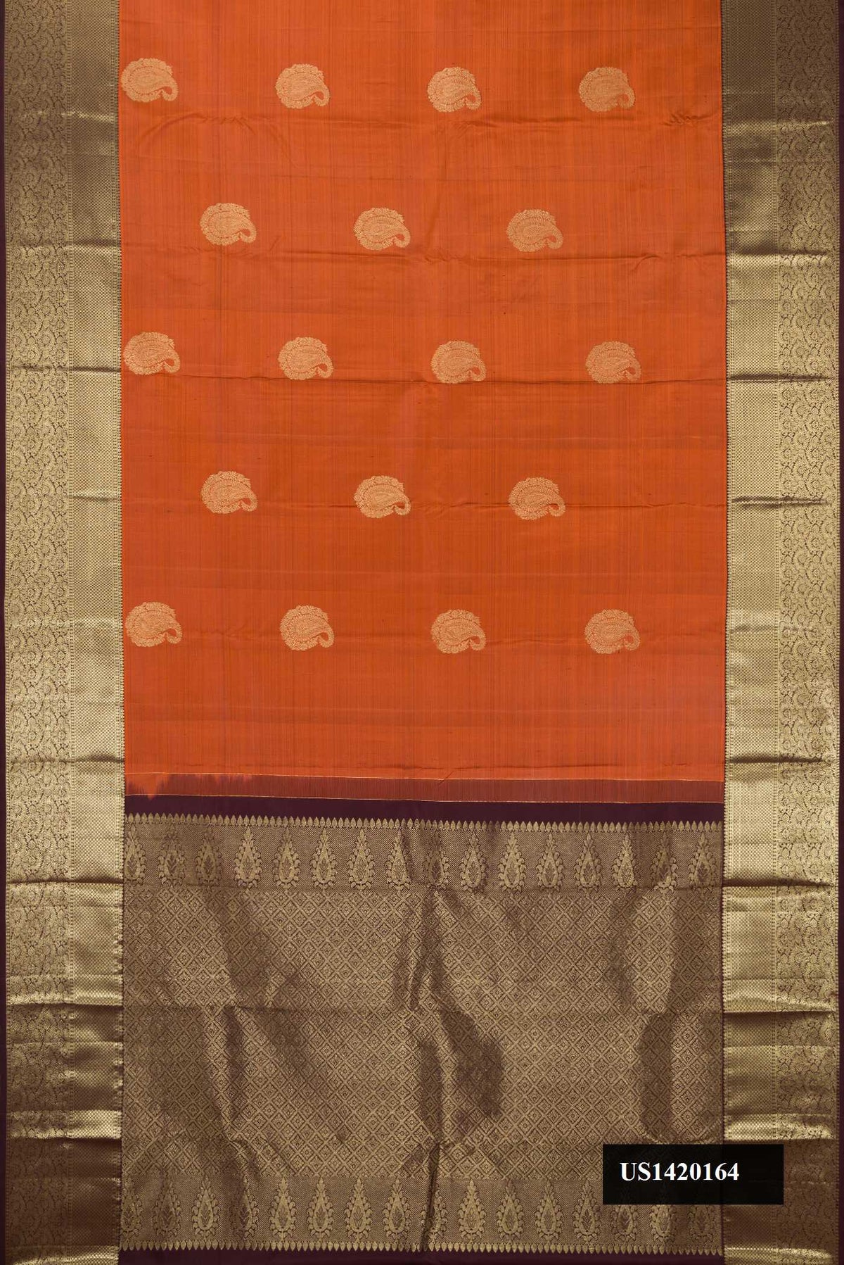Rust Dual Tone Kanchipuram Silk Saree with Zari Butta on the body and Zari Border.  displayed on a mannequin