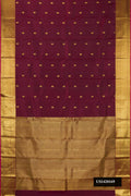Maroon Dual Tone Kanchipuram Silk Saree with Zari Butta on the body and Zari Border.  displayed on a mannequin