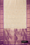 Beige Dual Tone Kanchipuram Silk Saree with Zari Butta on the body and Zari Border.  displayed on a mannequin