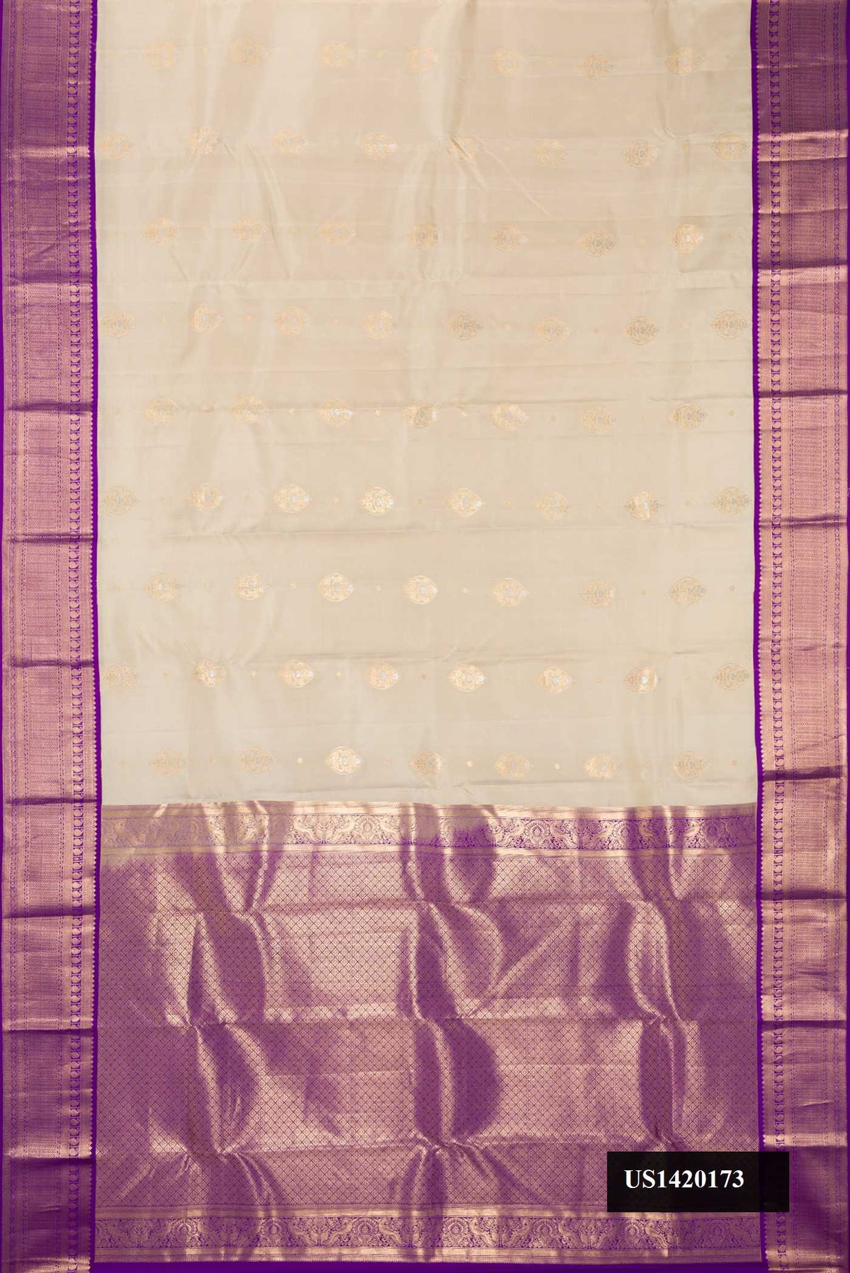 Beige Dual Tone Kanchipuram Silk Saree with Zari Butta on the body and Zari Border.  displayed on a mannequin