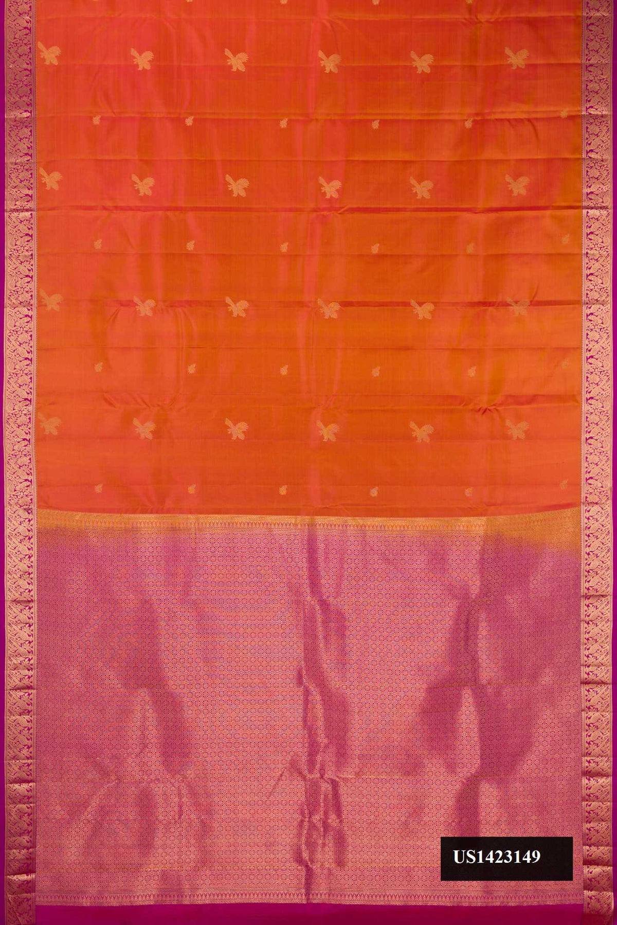 Rust Dual Tone Kanchipuram Silk Saree with Zari Butta on the body and Zari Border.  displayed on a mannequin