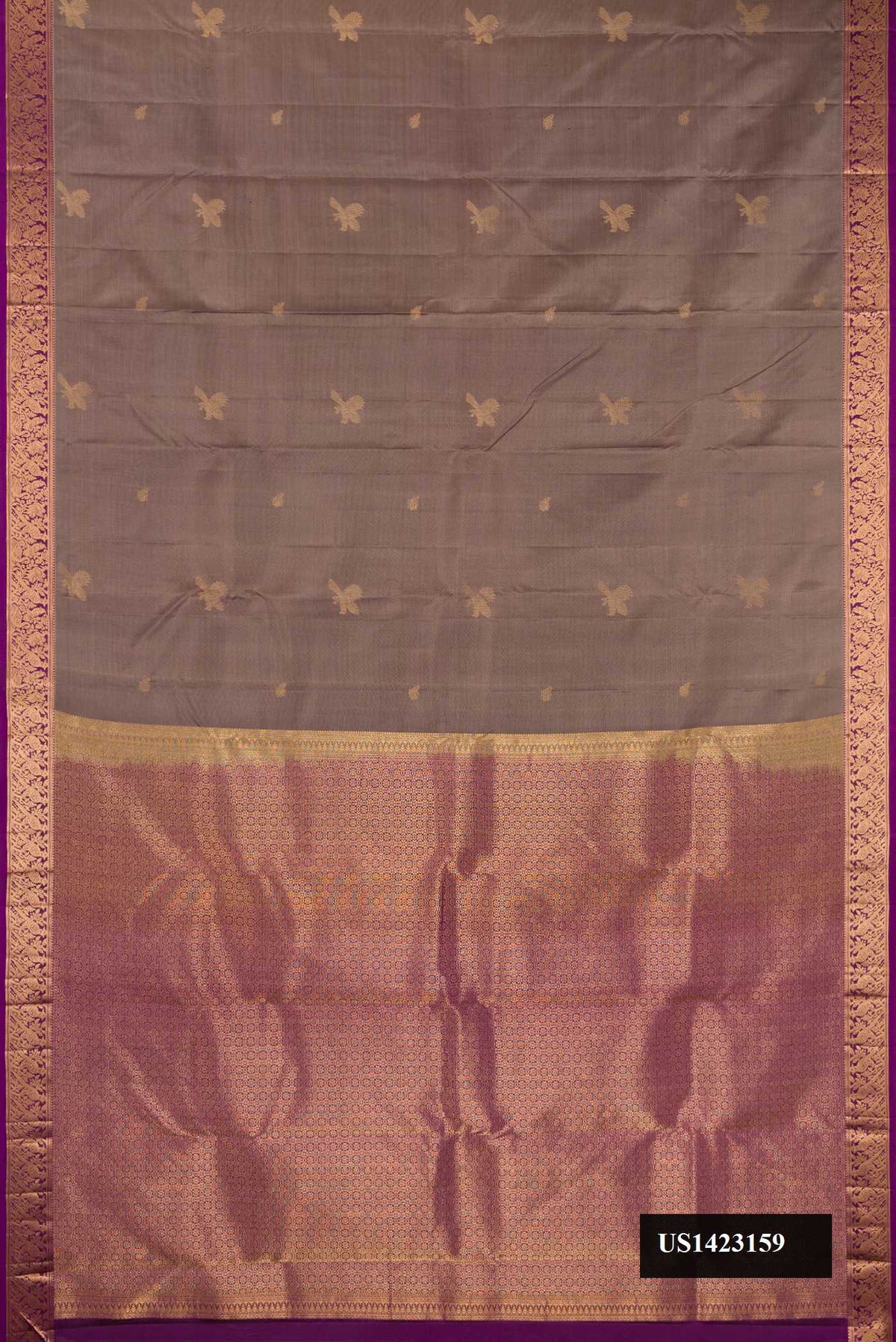 Brown Dual Tone Kanchipuram Silk Saree with Zari Butta on the body and Zari Border.  displayed on a mannequin