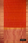 Rust Dual Tone Kanchipuram Silk Saree with Zari Butta on the body and Zari Border.  displayed on a mannequin