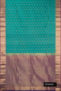 Green Dual Tone Kanchipuram Silk Saree with Zari Butta on the body and Zari Border.  displayed on a mannequin