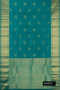 Green Dual Tone Kanchipuram Silk Saree with Zari Butta on the body and Zari Border.  displayed on a mannequin