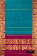 Peacock Blue Dual Tone Kanchipuram Silk Saree with Stripes on the body and Zari Border.  displayed on a mannequin