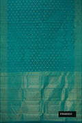 Green Dual Tone Kanchipuram Silk Saree with Zari Butta on the body and Zari Border.  displayed on a mannequin