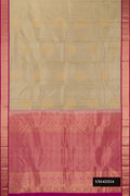 Beige Dual Tone Kanchipuram Silk Saree with Zari Butta on the body and Zari Border.  displayed on a mannequin